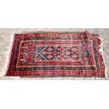 A SMALL 20TH CENTURY PERSIAN PRAYER RUG, black ground with stylised motifs. 5ft 0ins x 2ft 9ins.