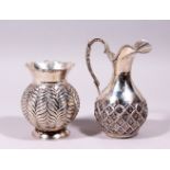 A CONTINENTAL SILVER JUG, with embossed decoration, with a similar vase, both stamped 900. Jug: 6.