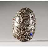 A GOOD LARGE RUSSIAN SILVER EGG, decorated with dragonfly and flowers, set with cabochon stones.