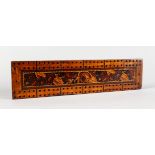 A TUNBRIDGE WARE MARQUETRY CRIBBAGE BOARD, on four ball feet. 9.25ins long x 2.25ins wide.