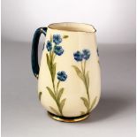 A MOORCROFT POTTERY MACINTYRE JUG. Made for JONES & HIGGIN, PECKHAM, No. 2830, cream ground with