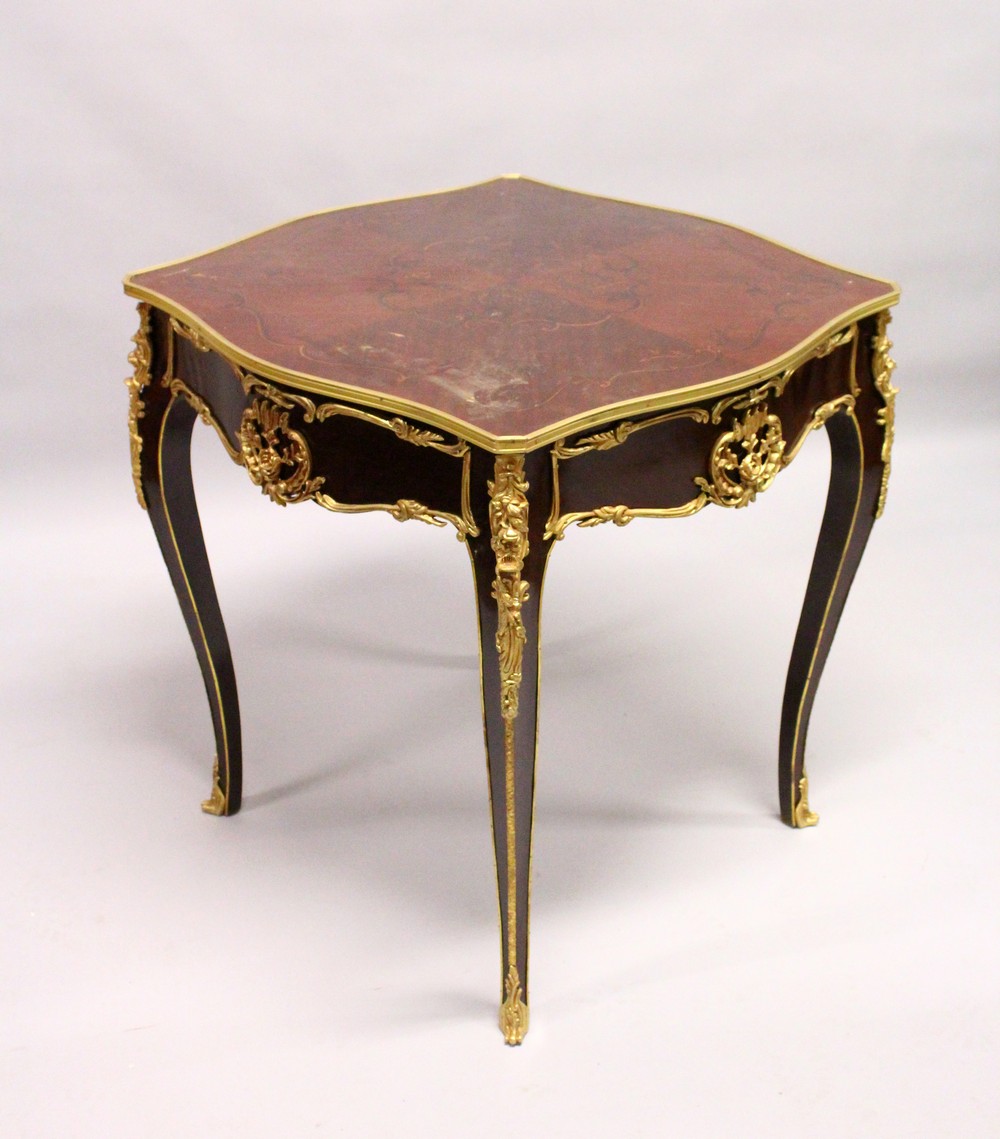 A LOUIS XVI STYLE INLAID MAHOGANY AND ORMOLU MOUNTED CENTRE TABLE, on cabriole legs. 2ft 5ins x