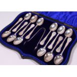 A GOOD SET OF TWELVE SPOONS and SUGAR TONGS, in a leather case. Sheffield 1910. Maker: T.L.