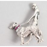 A DECO DESIGN SILVER BROOCH, lady walking a dog.