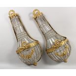 A PAIR OF BRASS AND CUT GLASS CHANDELIER STYLE WALL LIGHTS. 28ins high.