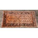 A SMALL 20TH CENTURY PERSIAN DESIGN RUG, rust ground with two tree design motifs. 3ft 7ins x 2ft