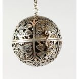 A PIERCED CHINESE SILVER BALL, on a chain. 2ins diameter.