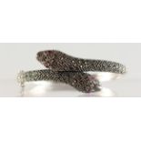 A SILVER AND MARCASITE ENTWINED SNAKE BRACELET.