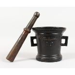 A HEAVY TWIN-HANDLED CAST IRON PESTLE AND MORTAR, signed and numbered. 6ins high.