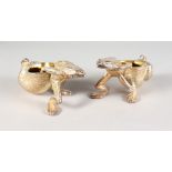 A PAIR OF SILVER PLATE FROG SALTS.