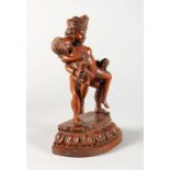 AN EROTIC CARVED WOOD FIGURE GROUP.