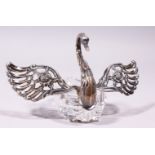 A CUT GLASS .835 SILVER SWAN, with silver head, neck and wings. 4.5ins long.