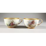 A FINE PAIR OF SEVRES BREAKFAST CUPS, each beautifully painted on each side with a courting