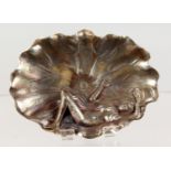 A CHINESE WHITE METAL LEAF SHAPED DISH, modelled as a naked woman on a lily pad. 5ins wide.