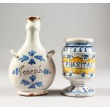 AN ITALIAN FAIENCE PEDESTAL DRUG JARS, "CHARITAS", probably 19th century, and a guglet labelled