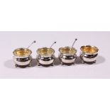 FOUR CHINESE SILVER SALTS, with three spoons. 1.75ins diameter.