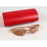 A PAIR OF CARTIER SUNGLASSES, Cartier Paris 110, in a Cartier folding red case.