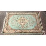 A 20TH CENTURY INDIAN CARPET, green ground with floral decoration. 8ft 10ins x 6ft 0ins.