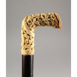 A GOOD LATE 19TH/EARLY 20TH CENTURY EBONY CANE WITH CARVED CANTON IVORY HANDLE. 36ins long.