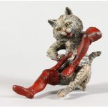 A COLD CAST BRONZE, a seated cat cleaning a large boot. 2.75ins high.