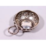 A CONTINENTAL SILVER WINE TASTER, embossed with a grape and vine leaf decoration. 2.25ins diameter.