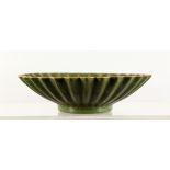 A CHINESE GREEN GROUND CRACKLE GLAZED DISH, of circular lobed form. 7.5ins diameter.