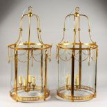 A LARGE PAIR OF GEORGE III STYLE BRASS CIRCULAR HALL LANTERNS. 2ft 8ins high.