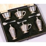 A SIX PIECE SILVER CRUET, comprising pair of circular salts, pair of mustard pots, all with sapphire