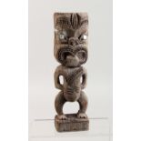 A MAORI TIKI CARVED WOOD FIGURE. 10ins high.