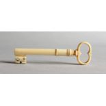 A RARE 19TH CENTURY IVORY NEEDLE CASE, in the form of a key. 3ins long.