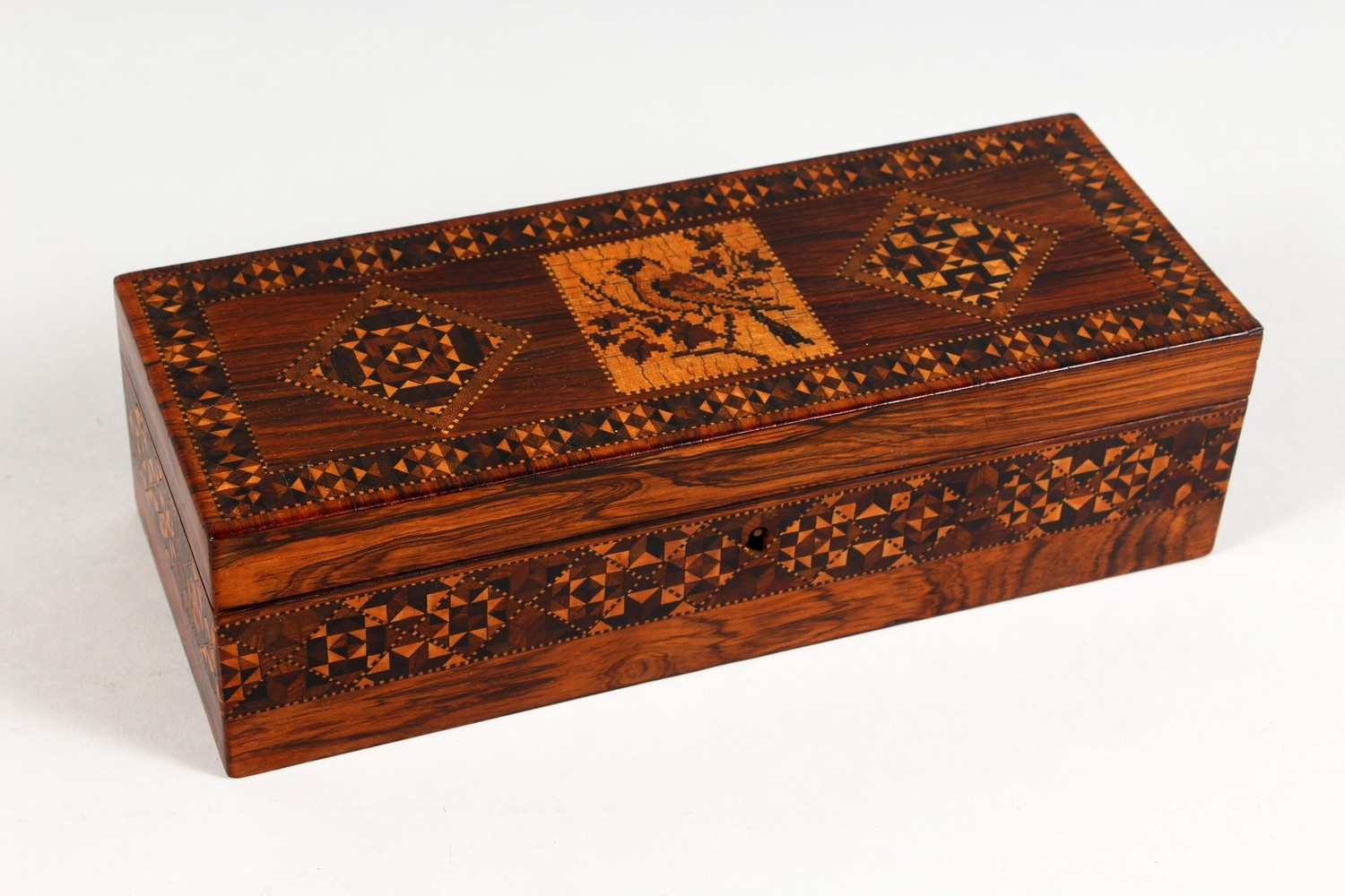 A GOOD TUNBRIDGE WARE LONG BOX, the hinged top inlaid with a bird and parquetry, parquetry to the