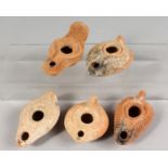 FIVE SMALL ROMAN POTTERY OIL LAMPS.