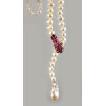 A STRING OF PEARLS with silver and ruby clasp.