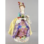 A CONTINENTAL PORCELAIN FIGURE OF A LADY, carrying a fan. 10ins high.