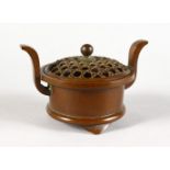 A GOOD SMALL CHINESE BRONZE TWO-HANDLED CENSER, with pierced lift-off top. 3ins diameter.
