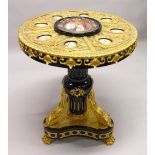 AN IMPRESSIVE EBONISED AND ORMOLU MOUNTED CIRCULAR PEDESTAL TABLE, inset with Sevres style oval