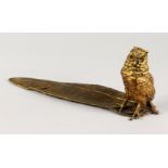 A VIENNA STYLE COLD PAINTED BRONZE, of a wise owl inkwell, standing on a feather. 13ins long.