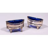 A PAIR OF GEORGE III BOAT SHAPED SALTS, with sapphire blue liners. Sheffield 1787. Maker: R.M.