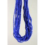 A LONG BLUE BEAD NECKLACE.