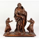 A 17TH CENTURY CARVED WOOD GROUP, the central figure as a stand, apostle with staff and bible,