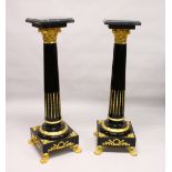 A PAIR OF IMPRESSIVE REGENCY STYLE EBONISED AND ORMOLU MOUNTED CORINTHIAN COLUMNS, with black marble
