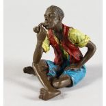 A COLD CAST BRONZE, a seated man smoking a pipe. 2.25ins high.