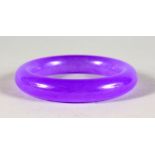 A CHINESE LAVENDER COLOUR JADE BANGLE. 3ins diameter.