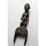 A CARVED WOOD FIGURAL TRIBAL PULLEY. 10ins high.