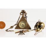 A BRASS NOVELTY SKULL WATCH and MASONIC WATCH and chain.