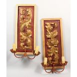 A PAIR OF 18TH CENTURY CARVED PANELS, with later light fittings and framed. 21ins high.