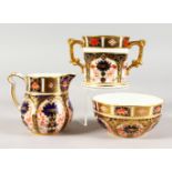 A ROYAL CROWN DERBY CREAM JUG AND SUGAR, painted with pattern 1128; together a with a matching two-