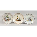 THREE 18TH CENTURY CONTINENTAL FAIENCE PLATES, with polychrome decoration, two depicting cherubs and