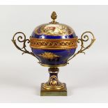 A SUPERB DARK BLUE GROUND SEVRES CIRCULAR TWO-HANDLED CENTREPIECE AND COVER, with rich gilt