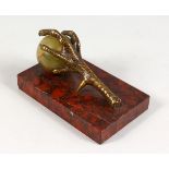 A BRONZE, ONYX AND ROUGE MARBLE PAPERWEIGHT, modelled as a claw and ball. 5.25ins long.